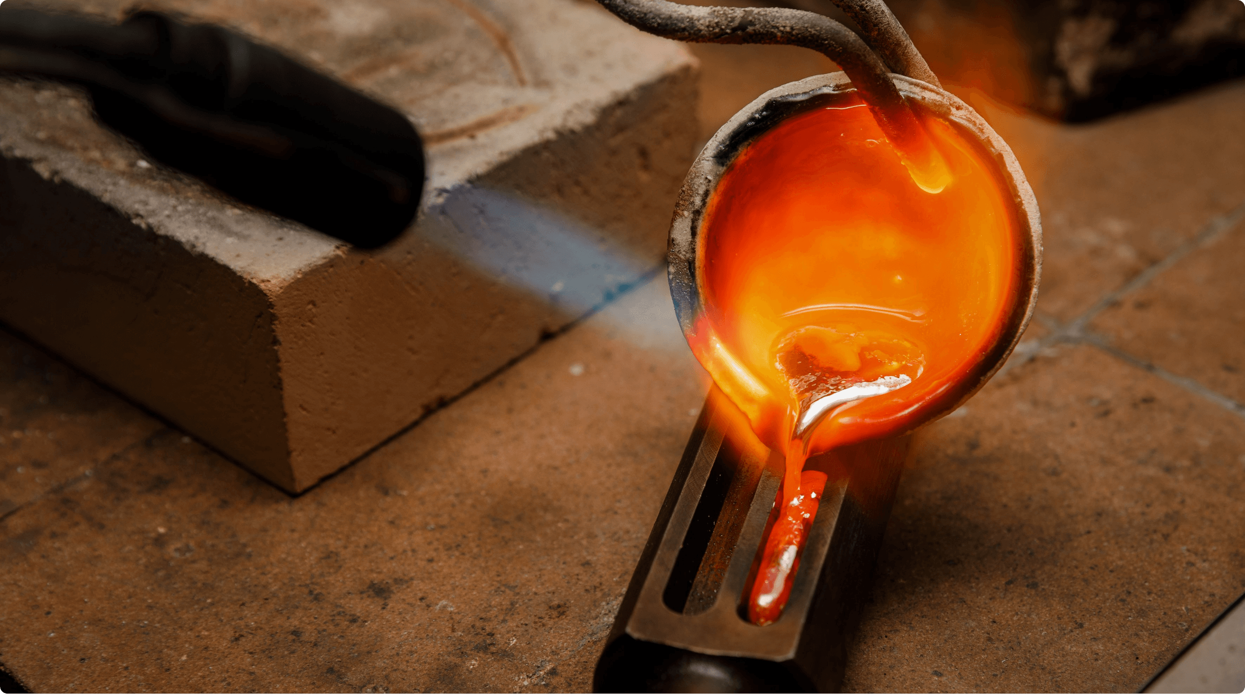 Image of red hot liquid being poured into mould