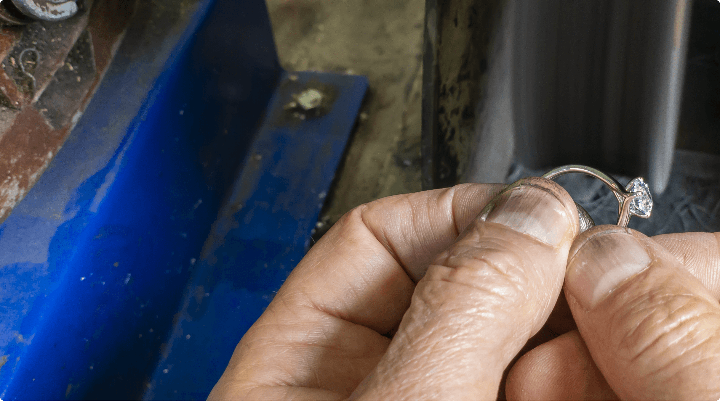 Close up image of ring detail being checked by hand